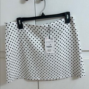 White with black polkadots, mini skirt from Zara brand.
